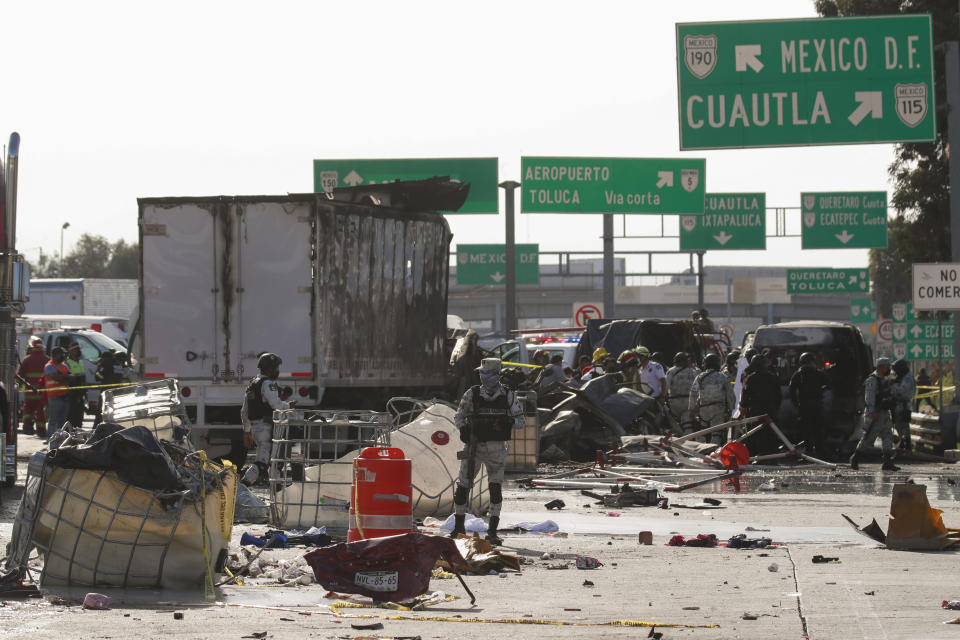 National Guard officers and rescue workers work the scene of an accident involving multiple vehicles, in Chalco, on the outskirt of Mexico City, Saturday, Nov. 6, 2021. At least 15 people were killed and another five injured in a multiple crash that occurred on a highway in central Mexico on Saturday, firefighters said. (AP Photo)