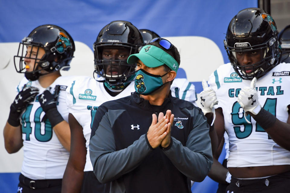 FILE - In this Saturday, Oct. 31, 2020, file photo, Coastal Carolina head coach Jamey Chadwell waits to lead his team onto the field before an NCAA football game against Georgia State in Atlanta. An unusual college football season has produced some unexpected unbeaten teams dotting the AP Top 25 with about a month left. Led by No. 7 Cincinnati and No. 8 BYU, five teams from outside the Power Five conferences have yet to lose. (AP Photo/John Amis, File)