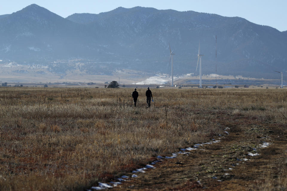 FILE - In this Sunday, Nov. 18, 2018 file photo, hikers head down a trail in the Rocky Flats National Wildlife Refuge in Broomfield, Colo. The former nuclear weapons plant northwest of Denver opened to hikers and cyclists in September 2018, but some activists question whether it’s safe. (AP Photo/David Zalubowski)
