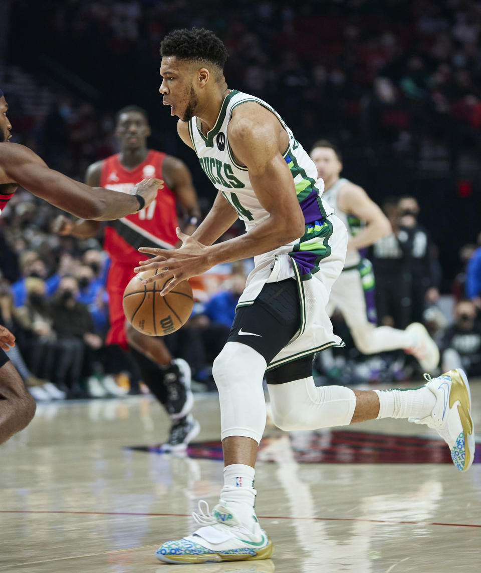 Milwaukee Bucks forward Giannis Antetokounmpo drives to the basket against the Portland Trail Blazers during the first half of an NBA basketball game in Portland, Ore., Saturday, Feb. 5, 2022. (AP Photo/Craig Mitchelldyer)