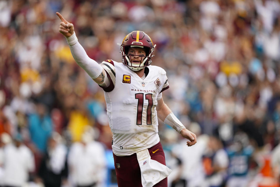 Washington Commanders quarterback Carson Wentz (11) reacting to making a two-point conversion against the Jacksonville Jaguars in the closing minutes of the second half of an NFL football game, Sunday, Sept. 11, 2022, in Landover, Md. (AP Photo/Patrick Semansky)