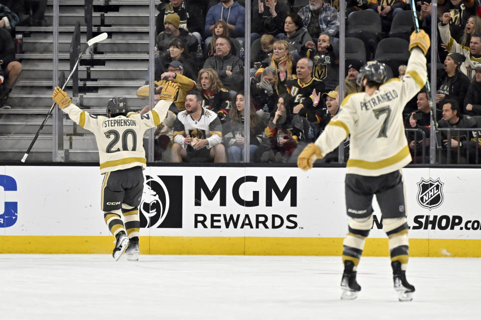 Vegas Golden Knights center Chandler Stephenson (20) and defenseman Alex Pietrangelo (7) react after Stephenson's goal during the third period of an NHL hockey game against the Calgary Flames, Saturday, Jan. 13, 2024, in Las Vegas. (AP Photo/David Becker)