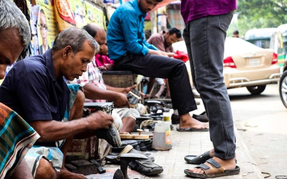 In emerging economies like Bangladesh, white-collar workers who once wore suits to work and stopped off to have their shoes shined are now forced to take up this low-paid job themselves - Susannah Savage