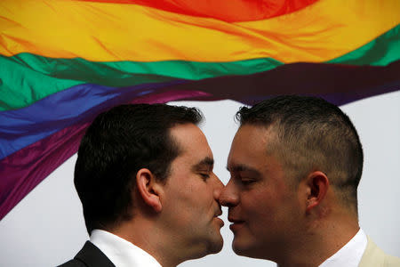 Chilean policeman Hugo Alcalde and Jose Luis Valdes are seen following their civil union celebration, after Alcalde became the first member of the police to get his civil union in the country, at Santiago, April 20, 2016. REUTERS/Carlos Vera