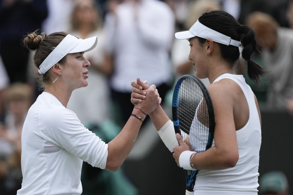 Elina Svitolina of Ukraine is congratulated by Xinyu Wang, right, of China following their fourth round match at the Wimbledon tennis championships in London, Monday, July 8, 2024. (AP Photo/Mosa'ab Elshamy)