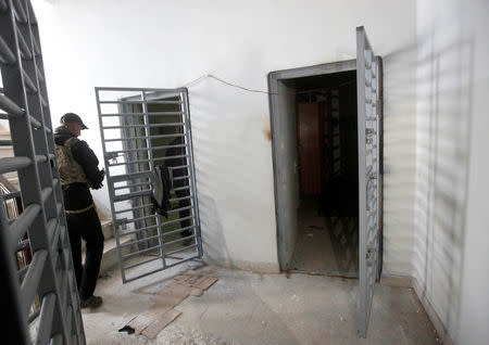 A member of Iraqi Counter-Terrorism Service (CTS) stands next to prisons used by Islamic State militants during a battle with Islamic State militants in east of Mosul, Iraq, January 21, 2017. REUTERS/Alaa Al-Marjani