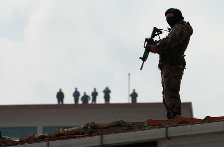 A member of police special forces stands guard on top of a building as Turkish President Tayyip Erdogan makes a speech during a ceremony in Istanbul, Turkey, March 26, 2017. REUTERS/Murad Sezer