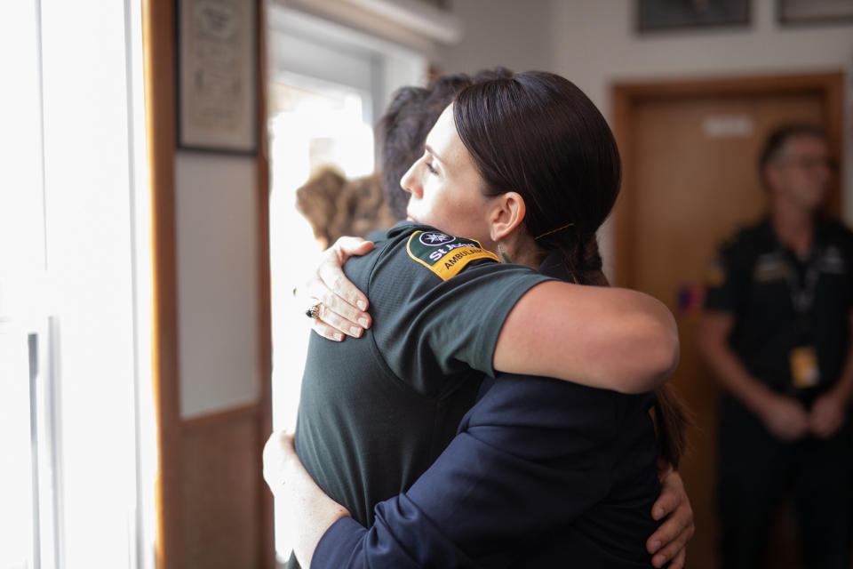 New Zealand Prime Minister Jacinda Ardern hugs a first responder who helped those injured in the White Island volcano eruption the day before, at the Whakatane Fire Station in Whakatane on Tuesday. (Photo: DOM THOMAS/AFP/pool photo via Getty Images)