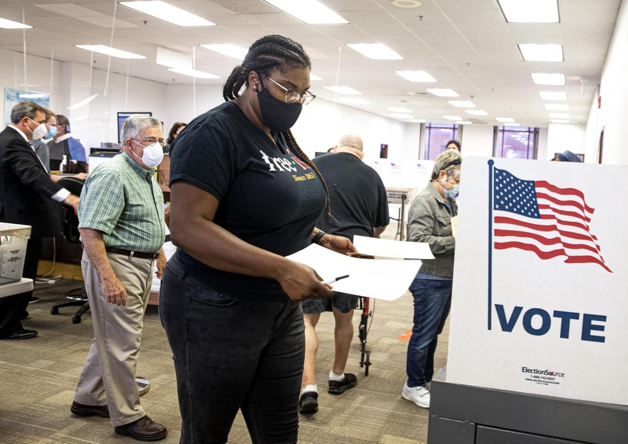 Sherema Douglass casts her ballot during on the first day of early voting at the Sangamon County Building on Sept. 24, 2020, in Springfield. This time, early voting extends through June 27.