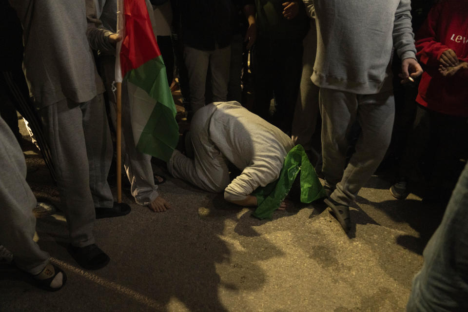 Former Palestinian prisoners who were released by the Israeli authorities, pray upon their arrival in the West Bank town of Beitunia, Friday, Nov. 24, 2023. The release came on the first day of a four-day cease-fire deal between Israel and Hamas during which the Gaza militants have pledged to release 50 hostages in exchange for 150 Palestinians imprisoned by Israel. (AP Photo/Nasser Nasser)