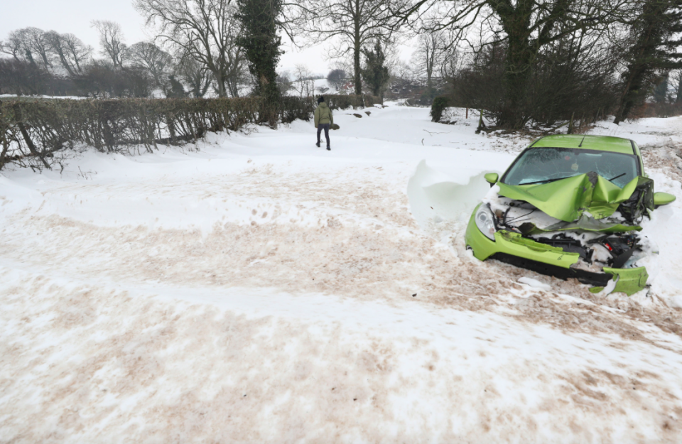 <em>An abandoned car lies at Belah bridge in Cumbria after snow battered the area (PA)</em>