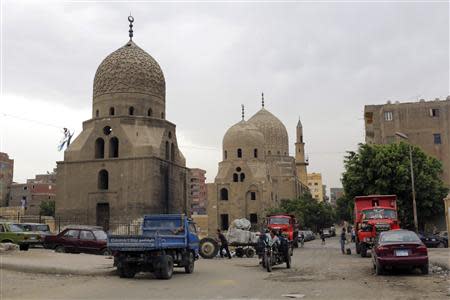 Vehicles are parked near the historic mosque of Al-Ashraf, which had its pulpit door stolen two years ago, in old Cairo April 19, 2014. REUTERS/Asmaa Waguih