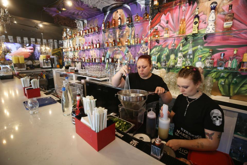 Bartenders Tammy Kaiser and Trinity Bryant make syrups. the restaurant makes all fresh juices and mixes.