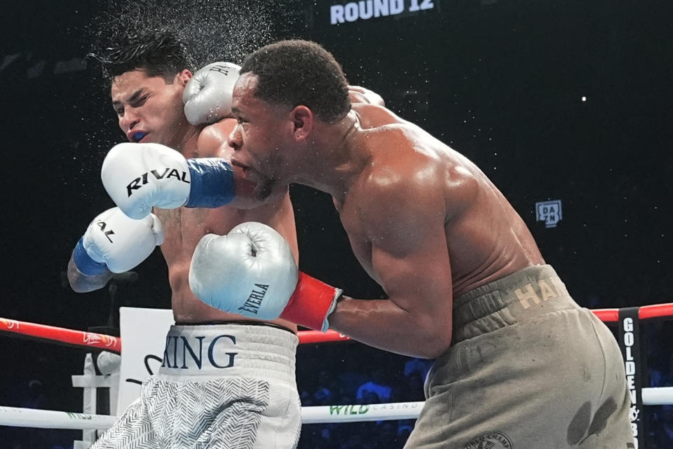 Devin Haney, right, punches Ryan Garcia during the 12th round of a super lightweight boxing match early Sunday, April 21, 2024, in New York. (AP Photo/Frank Franklin II)