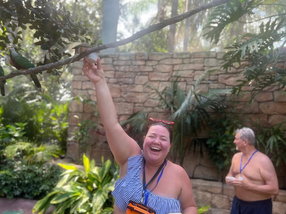 megan feeding a bird in the aviary at discovery cove in orlando