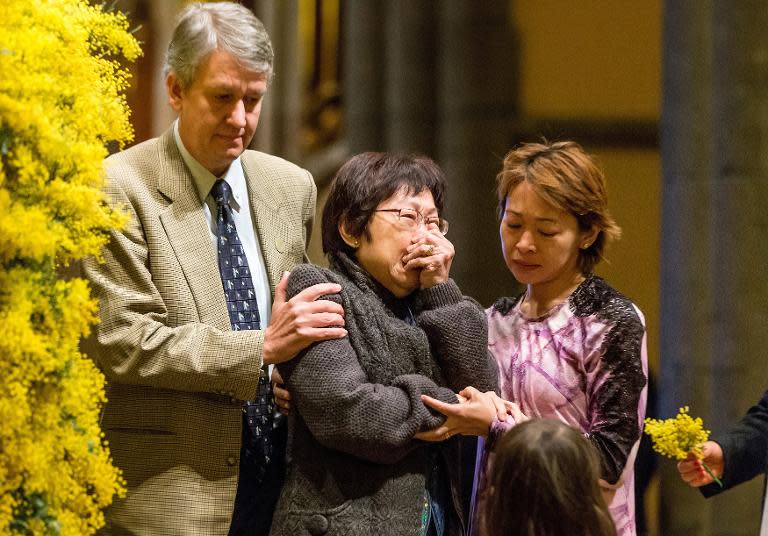 Relatives of victims of downed Flight MH17 grieve at St. Patrick's Cathedral in Melbourne on August 7, 2014 during a national day of mourning