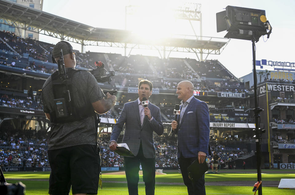 MLB broadcasters Mike Pomeranz, left, and Mark Sweeney work on a broadcast before a baseball game between the Los Angeles Angels and the San Diego Padres on Monday, July 3, 2023, in San Diego. MLB recognized late in 2022 that Diamond Sports might not be able to fulfill its contracts to broadcast games for its 19 regional sports networks and the sport began making contingencies. (AP Photo/Denis Poroy)