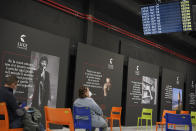 People sit in a waiting room after receiving a dose of the Pfizer COVID-19 vaccine, at a vaccination center set at Rome's Cinecitta' film studios, Tuesday, April 20, 2021. (AP Photo/Andrew Medichini)