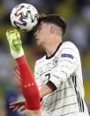 France's Adrien Rabiot, left, battles for the ball with Germany's Kai Havertz, right, during the Euro 2020 soccer championship group F match between France and Germany at the Allianz Arena in Munich, Germany, Tuesday, June 15, 2021. (AP Photo/Matthias Schrader, Pool)