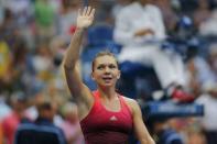 Simona Halep of Romania waves to the crowd as she celebrates after defeating Victoria Azarenka of Belarus in their quarterfinals match at the U.S. Open Championships tennis tournament in New York, September 9, 2015. REUTERS/Eduardo Munoz