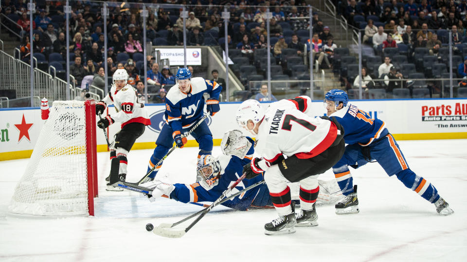 New York Islanders goaltender Ilya Sorokin (30) deflects a shot by Ottawa Senators left wing Brady Tkachuk (7) during the second period of an NHL hockey game Tuesday, Feb. 14, 2023, in Elmont, N.Y. (AP Photo/Eduardo Munoz Alvarez)