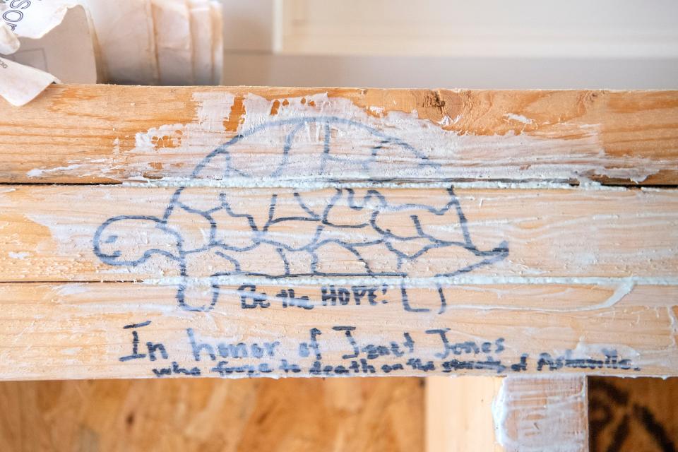 A tribute to Janet Jones, the catalyst for the BeLoved Asheville Village, is drawn on one of the beams inside the model home of the future community. Jones, who loved turtles, froze to death while sleeping by the French Broad River in 2016. 