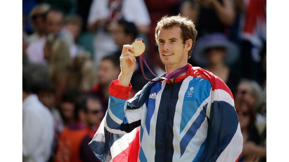 Andy Murray holds up gold medal