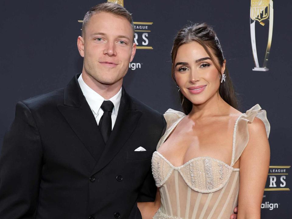 <p>Ethan Miller/Getty</p> Christian McCaffrey and Olivia Culpo in 2023