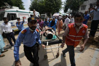A passenger injured in a bus accident in Jammu and Kashmir's Poonch district is brought for treatment at a hospital in Jammu, India, Wednesday, Sept.14, 2022. Nearly a dozen people died and more people were injured when a mini-bus plunged into a deep gorge Wednesday. (AP Photo/Channi Anand)