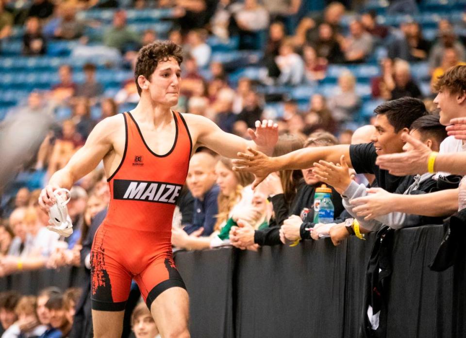 Maize’s Connor Padgett celebrates with the crowd after winning a Class 5A state championship.