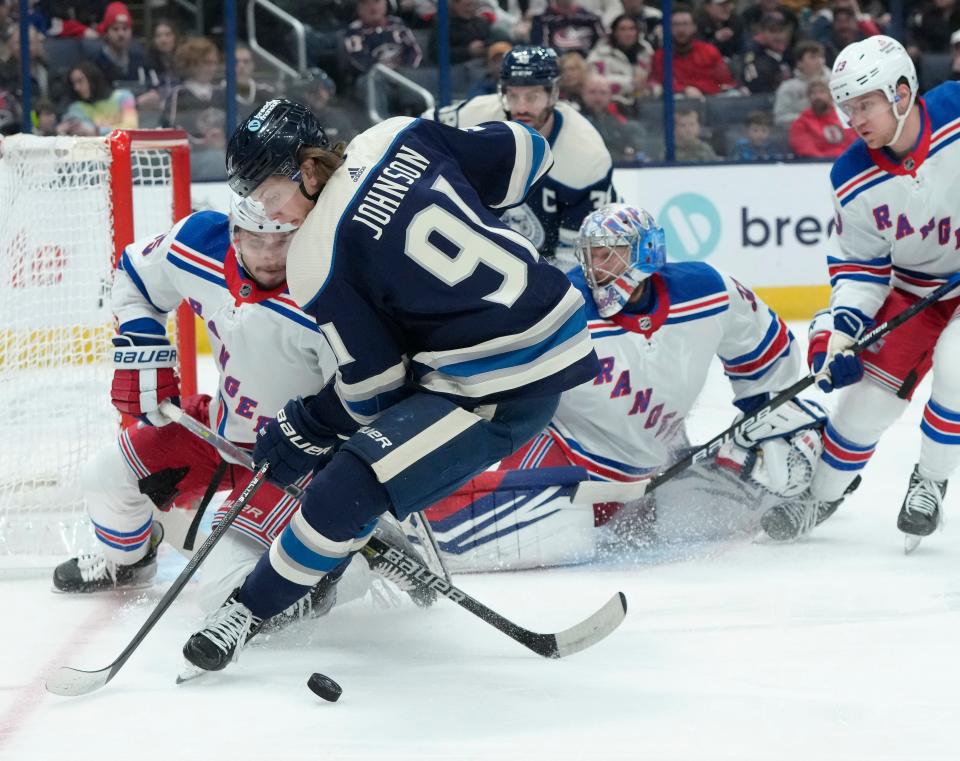 Feb. 25, 2024; Columbus, Ohio, USA; 
New York Rangers defenseman Ryan Lindgren (55) saves a puck from Columbus Blue Jackets center Kent Johnson (91) during the first period of an NHL game at Nationwide Arena on Sunday.