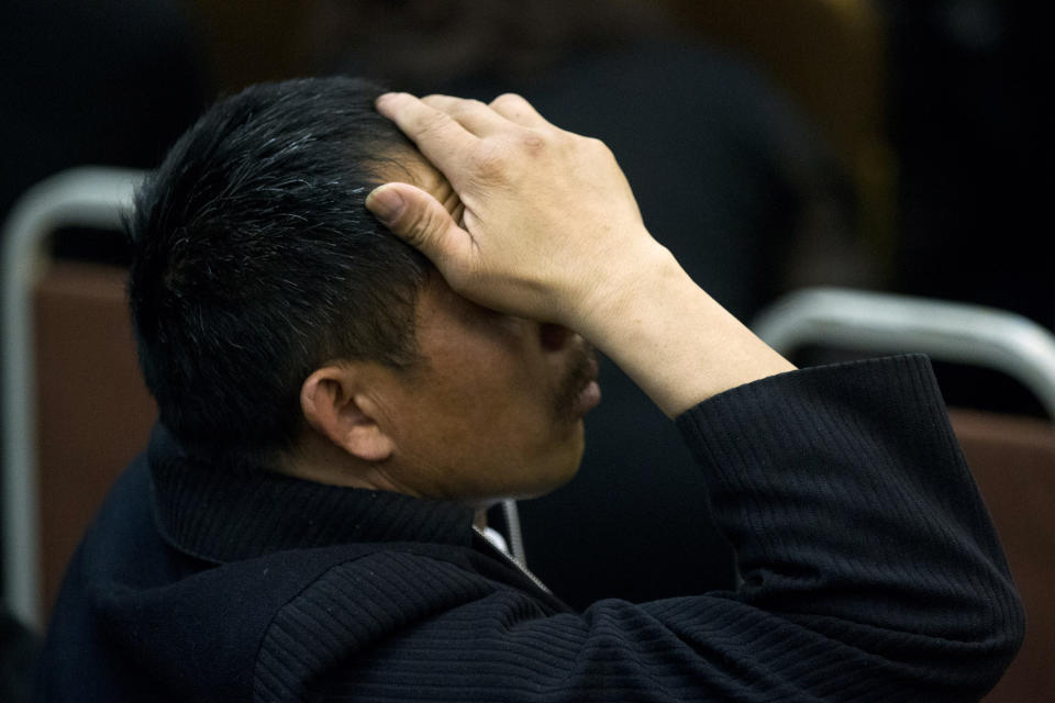 One of the relatives of Chinese passengers on board Malaysia Airlines Flight 370 rubs his head during a briefing meeting given by Malaysian official at a hotel in Beijing, China, Wednesday, March 26, 2014. The search of the missing plane resumed Wednesday after fierce winds and high waves forced crews to take a break Tuesday. A total of 12 planes and five ships from the United States, China, Japan, South Korea, Australia and New Zealand were participating in the search, hoping to find even a single piece of the jet that could offer tangible evidence of a crash and provide clues to find the rest of the wreckage. (AP Photo/Alexander F. Yuan)