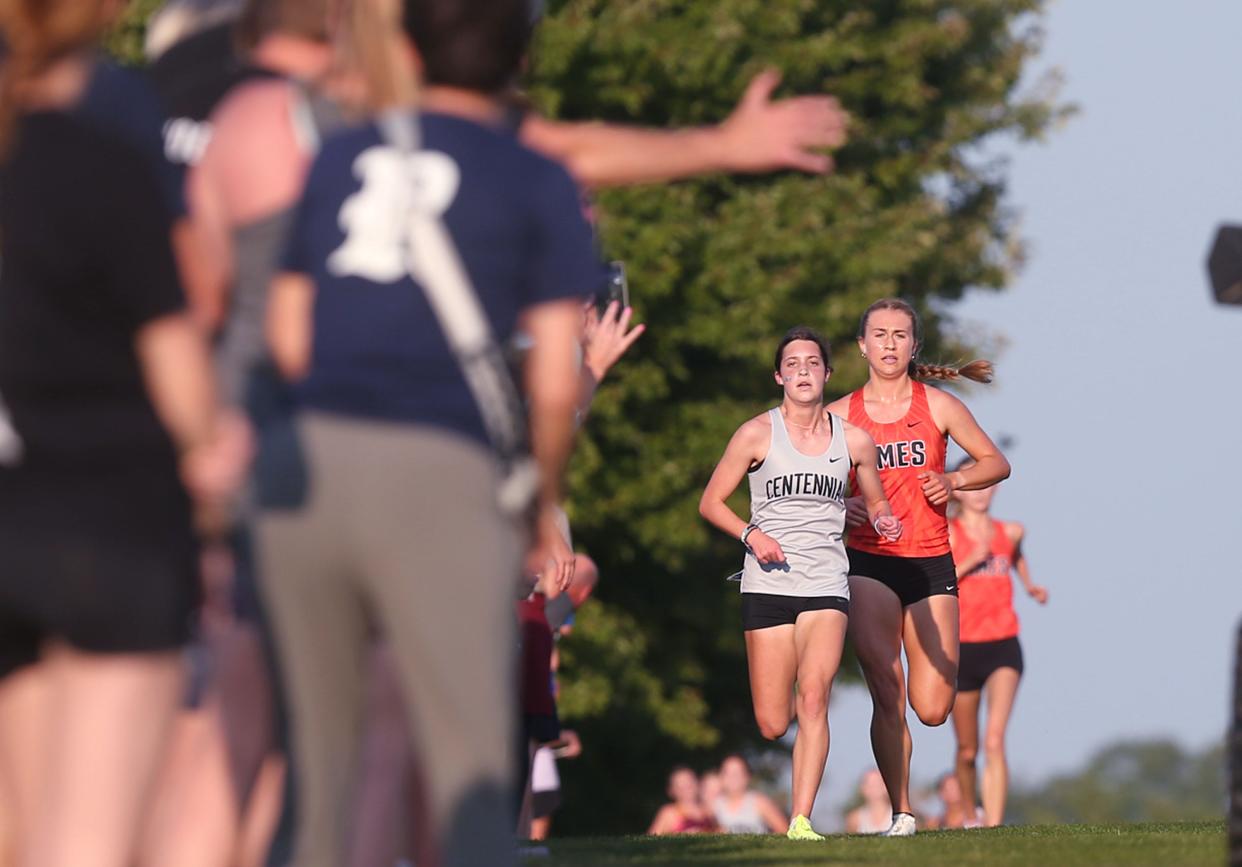 Ames’ Marley Turk and Ankeny Centennial's Anika Mohrhauser battle for the lead in the Kirk Schmaltz Invitation varsity girls cross country race at the Iowa State Cross Country Course on Thursday, Sept. 5, 2024, in Ames, Iowa.