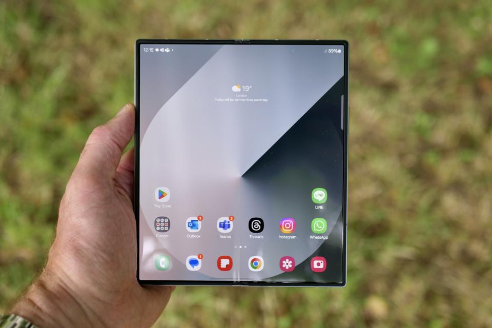 A person holding an open Samsung Galaxy Z Fold 6.