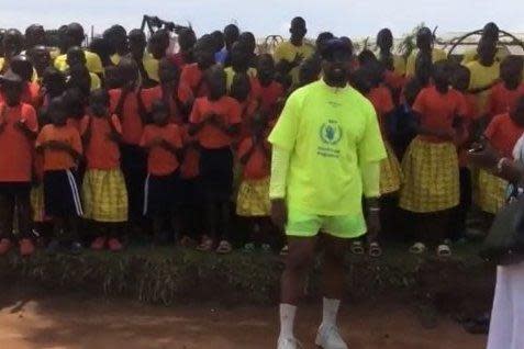 Donations: Kanye West posing proudly with Ugandan school children (Instagram/ Kim Kardashian)