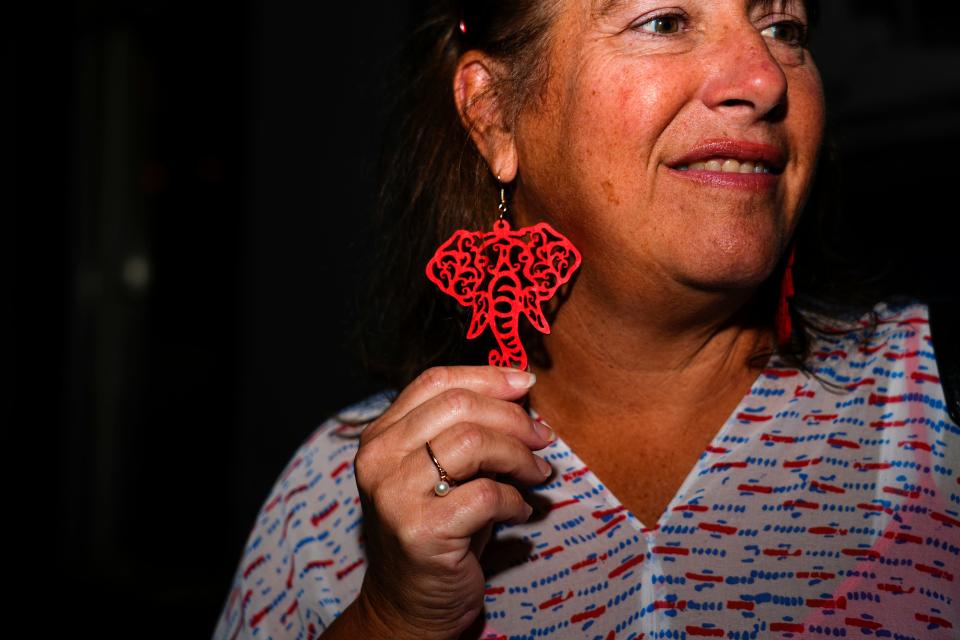 Lynn Berk, of Taylor Mill, Ky., shows off her red elephant earrings she’s wearing during the Kenton County Republicans election night party on Tuesday, Nov. 7, 2023, at The Globe in Covington, Ky. An elephant is the official symbol for the Republican Party, first popularized by cartoonist Thomas Nast back in the 1870s.