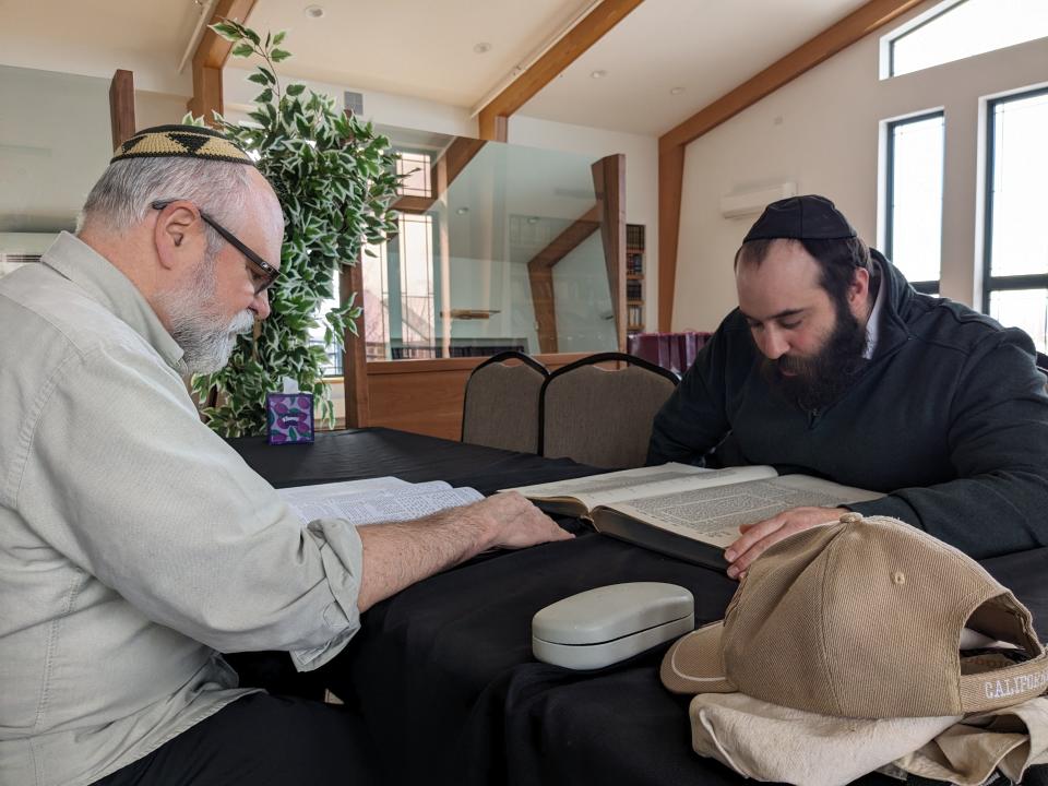 Rabbi Eliyahu Junik, right, studies Torah with Bruce Hickes, who attends Chabad of Vermont's synagogue.