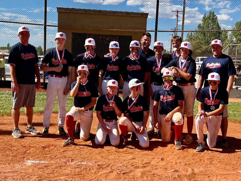 Washington Little League All-Stars. Front row, left to right: Genevieve Evans, Jace Duston, Jeric Wilson, Josh Gray, Jaxton Probst. Back row, left to right: Coach Wayne Evans, Ammon Johanson, Brooks Clark, Wyatt Mitchell, Ezra Lewellen, coach Sean Mawhinney, Blake Mawhinney, Tristan Sylvester, Rayce Bennett, coach David Gray.