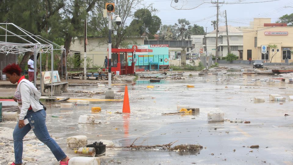 A woman walks through a street filled with debris in the Hastings neighborhood after Hurricane Beryl passed in Bridgetown, Barbados. - Nigel R Browne/Reuters