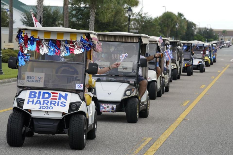 A parade of more than 300 golf carts supporting Je Biden caravan to the Sumter county elections office in Florida to cast their ballots on 7 October.