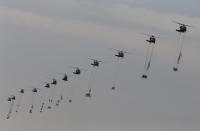 Members of the Special Warfare Command are suspended from army helicopters during a celebration marking the 65th anniversary of Korea Armed Forces Day, at a military airport in Seongnam, south of Seoul, October 1, 2013. (REUTERS/Kim Hong-Ji)