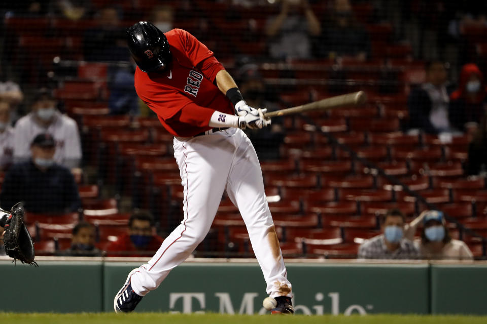 Boston Red Sox's J.D. Martinez fouls a ball off his foot during the seventh inning of a baseball game against the Toronto Blue Jays Tuesday, April 20, 2021, at Fenway Park in Boston. (AP Photo/Winslow Townson)