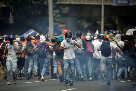 Opposition supporters clash with security forces during a rally against Venezuela's President Nicolas Maduro in Caracas, Venezuela, April 26, 2017. REUTERS/Marco Bello