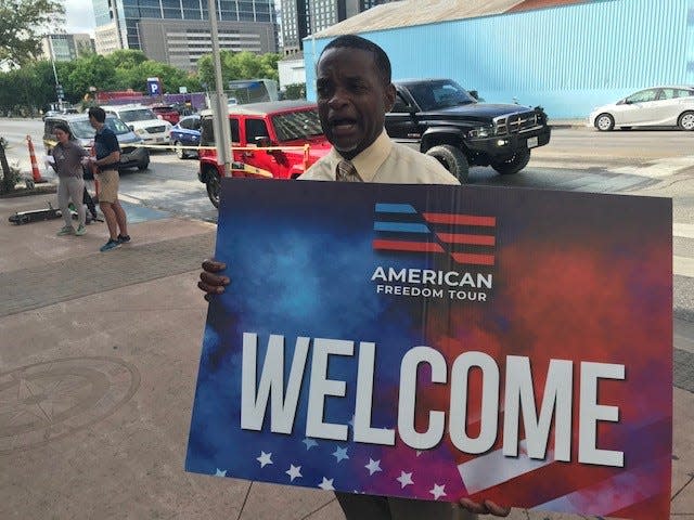 Pascal Jackson, a Trump event staff member, welcomes visitors to the Austin Convention Center. Jackson said people began arriving about 90 minutes early and were eager to get inside the venue. "The line was wrapped all the way around the block," he said.