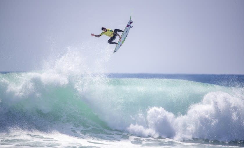 Gabriel Medina soars high on a big wave as he beats fFilipe Toledo to win the World Surf League Championship Title