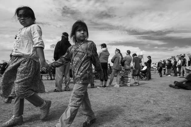 Two children walk together in a protest encampment near Cannon Ball, North Dakota, where protesters have gathered to voice their opposition to the Dakota Access Pipeline, Sept. 3, 2016. (Photo: ROBYN BECK via AFP via Getty Images)
