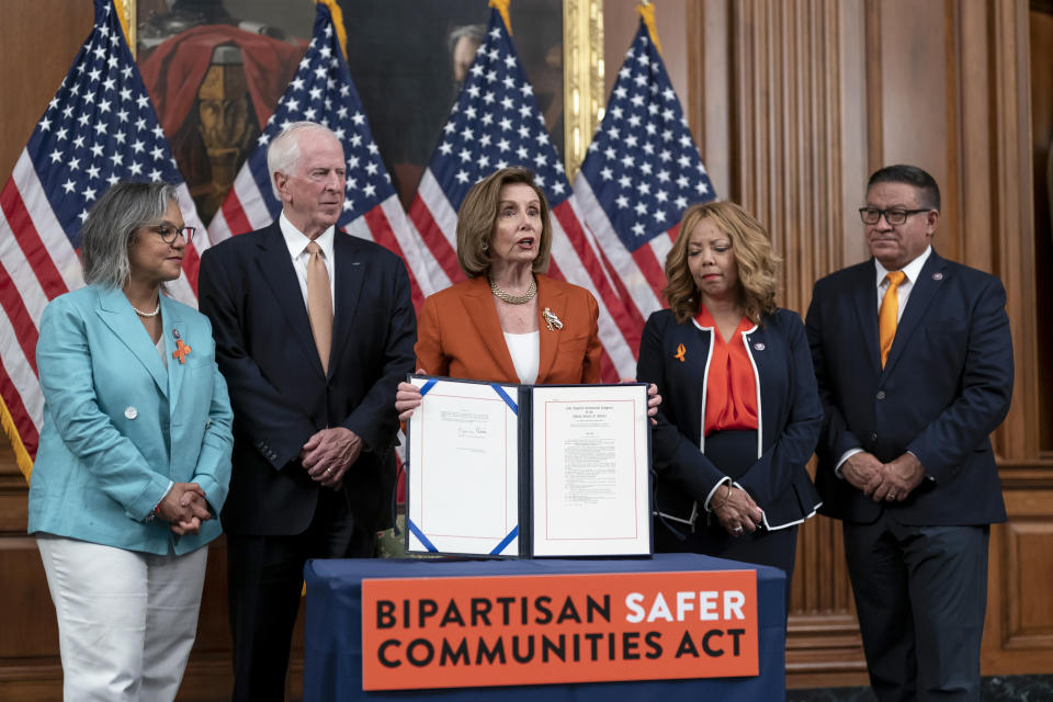 FILE - Speaker of the House Nancy Pelosi, D-Calif., center, is joined by, from left, Rep. Robin Kelly, D-Ill., Rep. Mike Thompson, D-Calif., chairman of the House Gun Violence Prevention Task Force, Rep. Lucy McBath, D-Ga., and Rep. Salud Carbajal, D-Calif., as she enrolls the gun violence safety bill before sending it to President Joe Biden to sign it into law, at the Capitol in Washington, June 24, 2022. (AP Photo/J. Scott Applewhite, File)