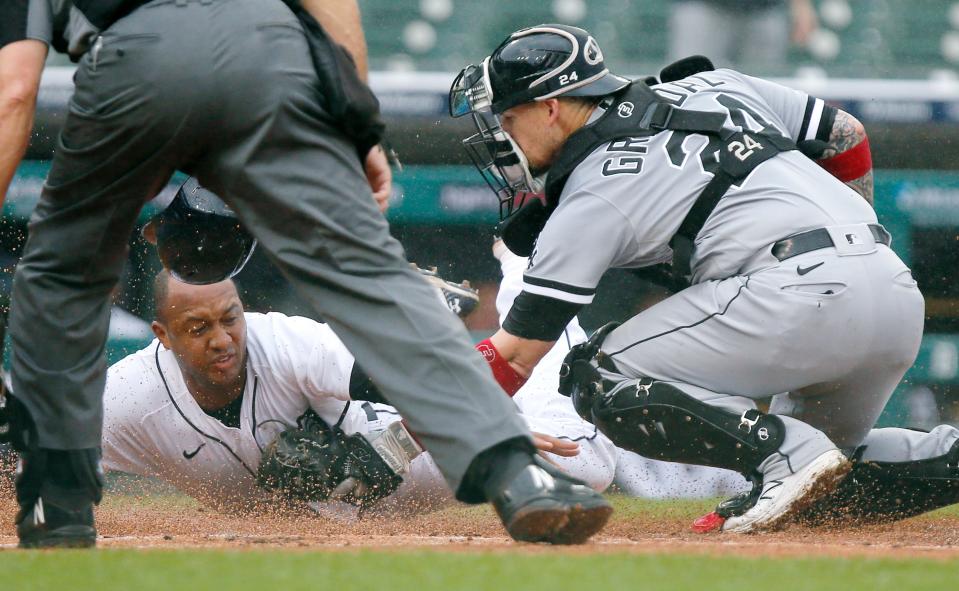 Tigers first baseman Jonathan Schoop is tagged out at home by White Sox catcher Yasmani Grandal while trying to score from first base on a double by Robbie Grossman during the first inning on Tuesday, Sept. 21, 2021, at Comerica Park.