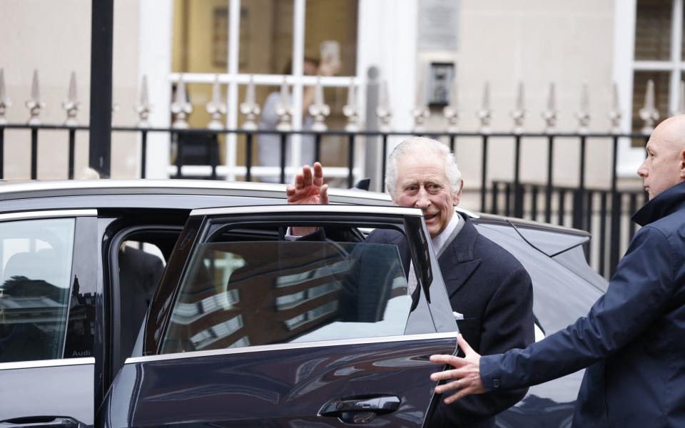 The King waves to well-wishers as he leaves the London Clinic after treatment
