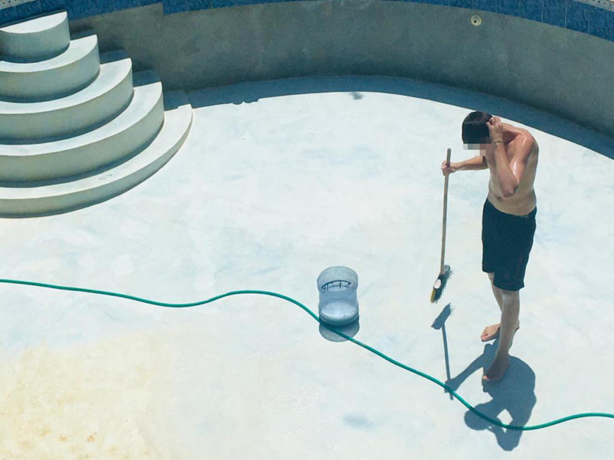 A boy cleans a pool at the Atlantis Leadership Academy. His face has been obscured by NBC News. (Obtained by NBC News)